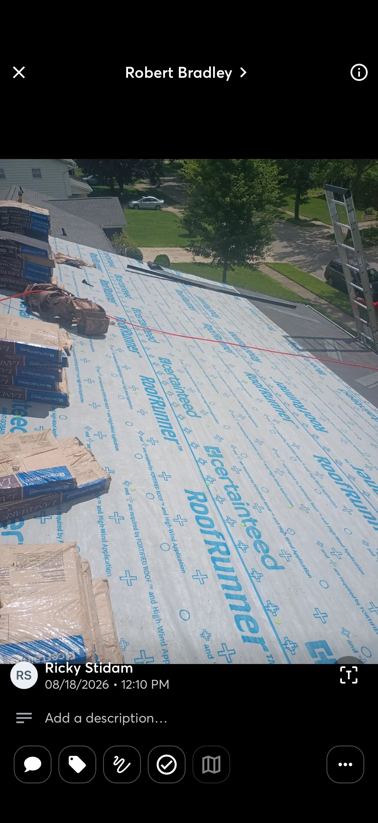 CertainTeed RoofRunner synthetic underlayment being installed on a sloped roof with shingle bundles staged nearby